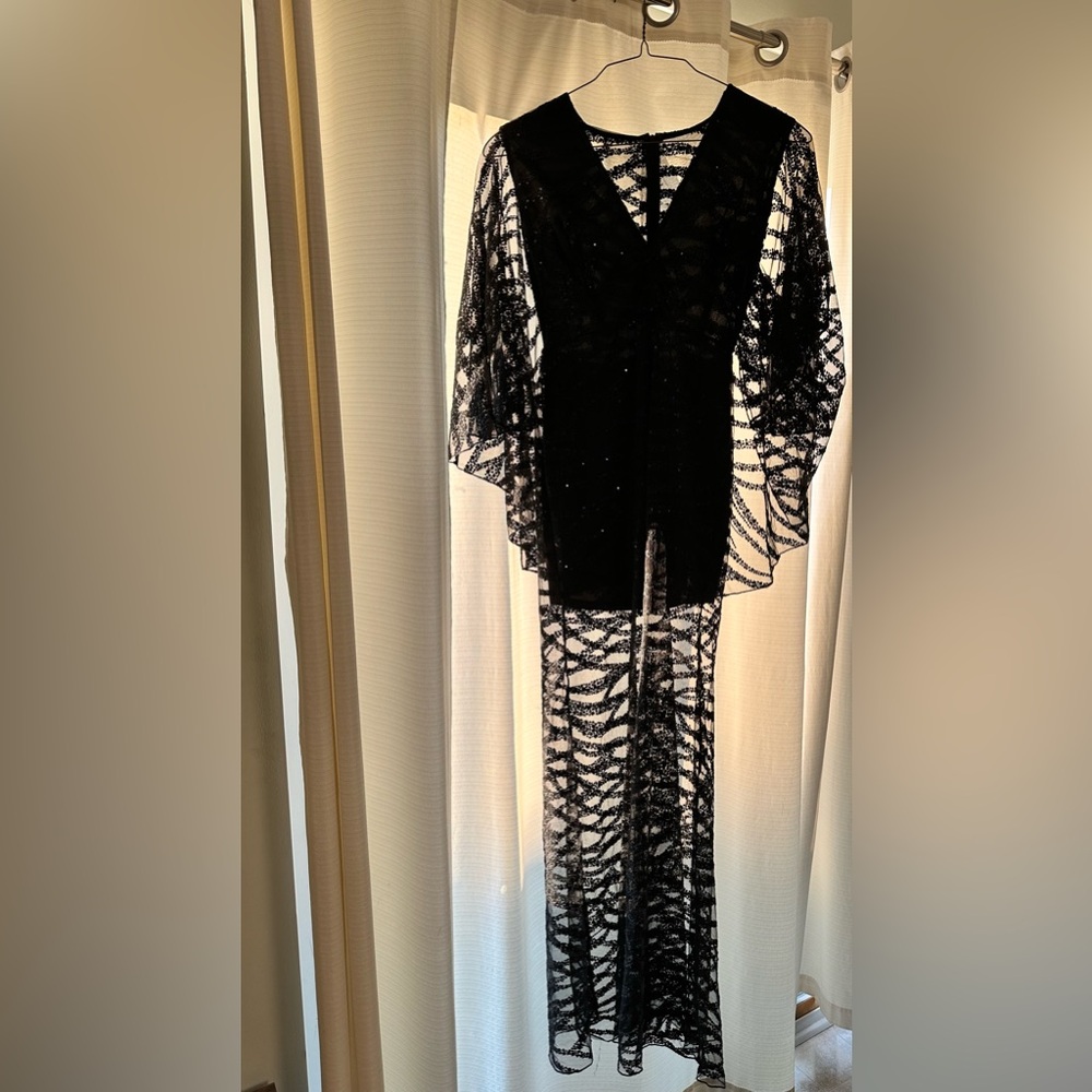 Black dress with cape on the back.